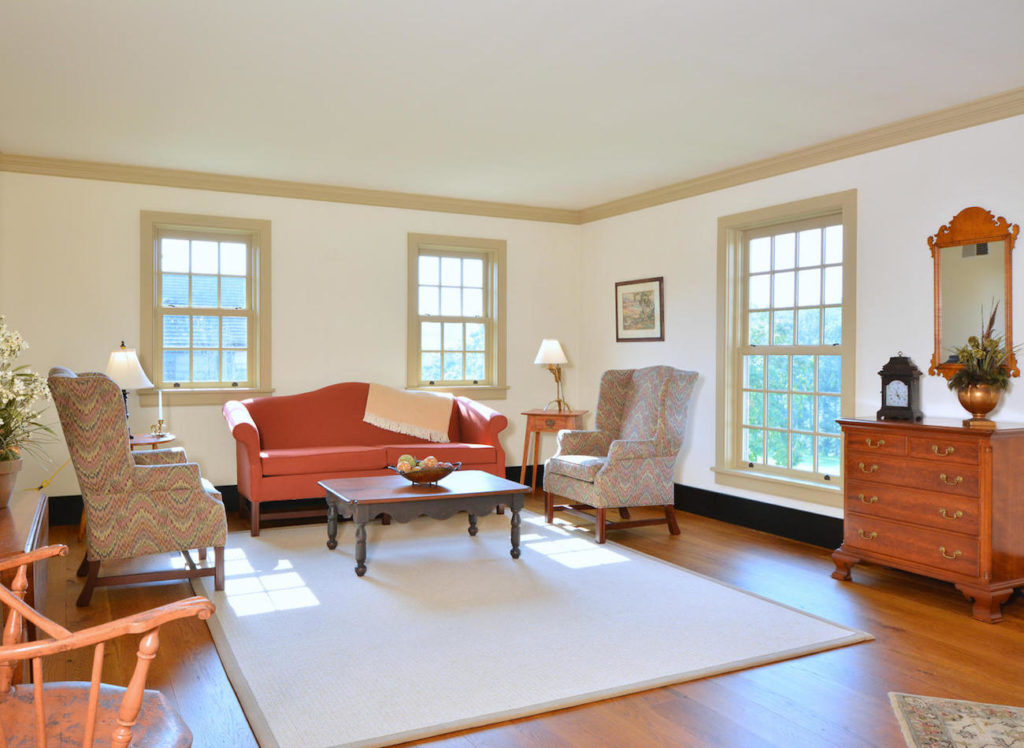 Living room with orange couch in an olde bulltown home