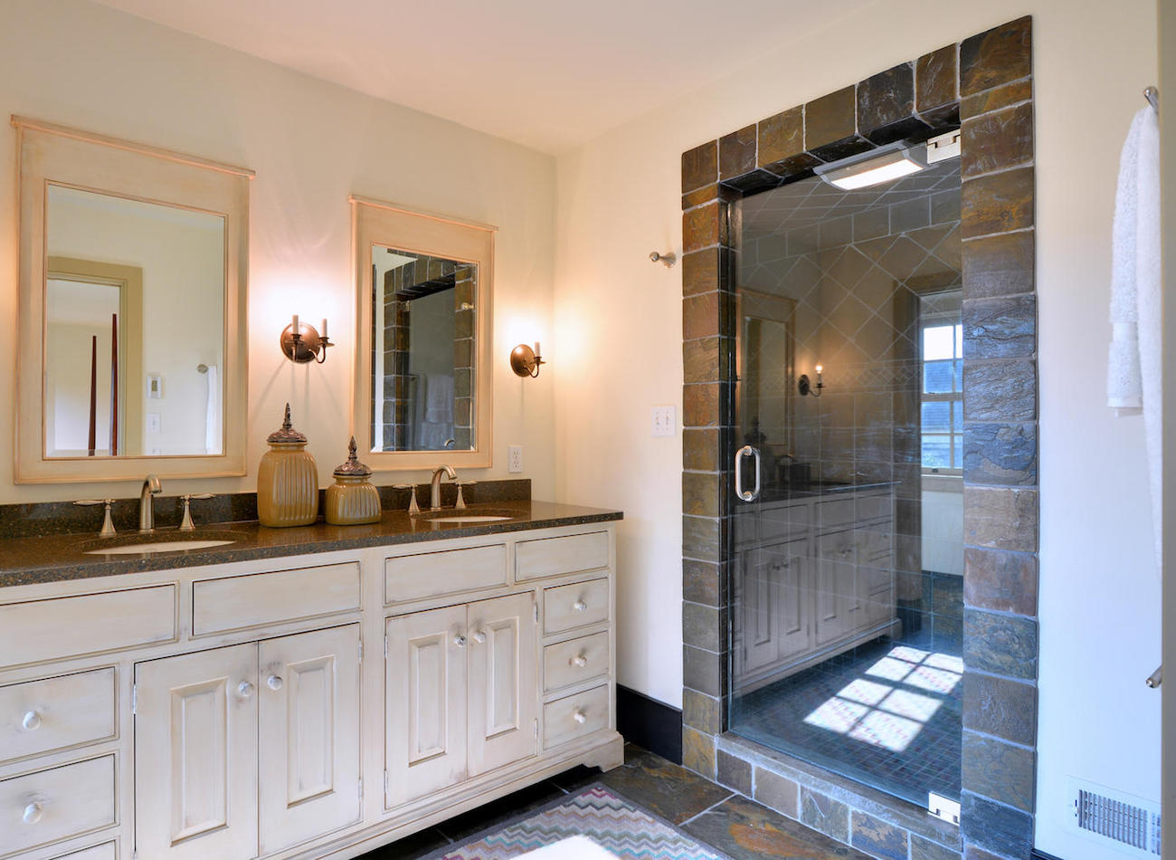 Full bathroom with two sinks and large shower in an olde bulltown home