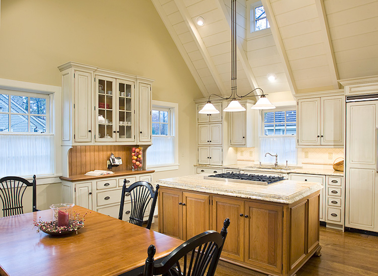 Kitchen with white cabinets and center island in an olde bulltown home