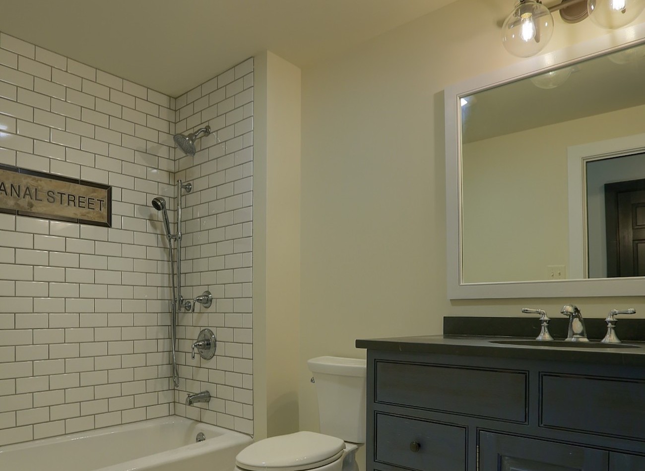 Full bathroom with black cabinets in an olde bulltown home