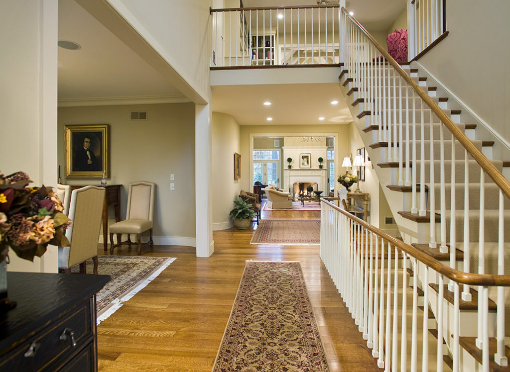 Hallway with stairs leading up in a large home in olde bulltown