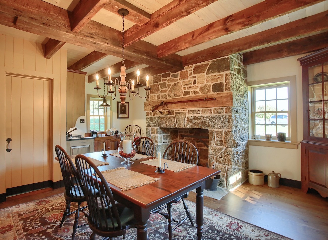 Dining room with stone fireplace in a home in olde bulltown