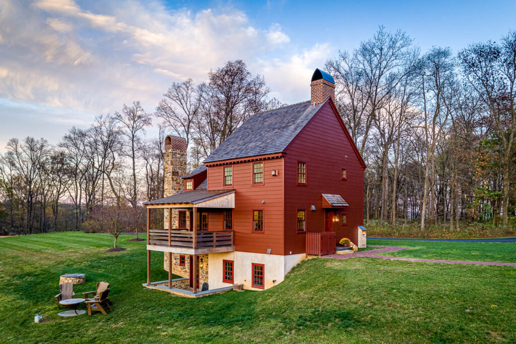 rear elevation of a red home with stone accents in olde bulltown
