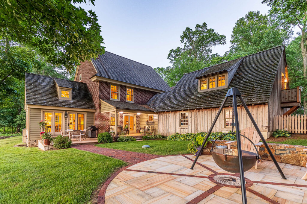 Back patio with hanging firepit and brick path
