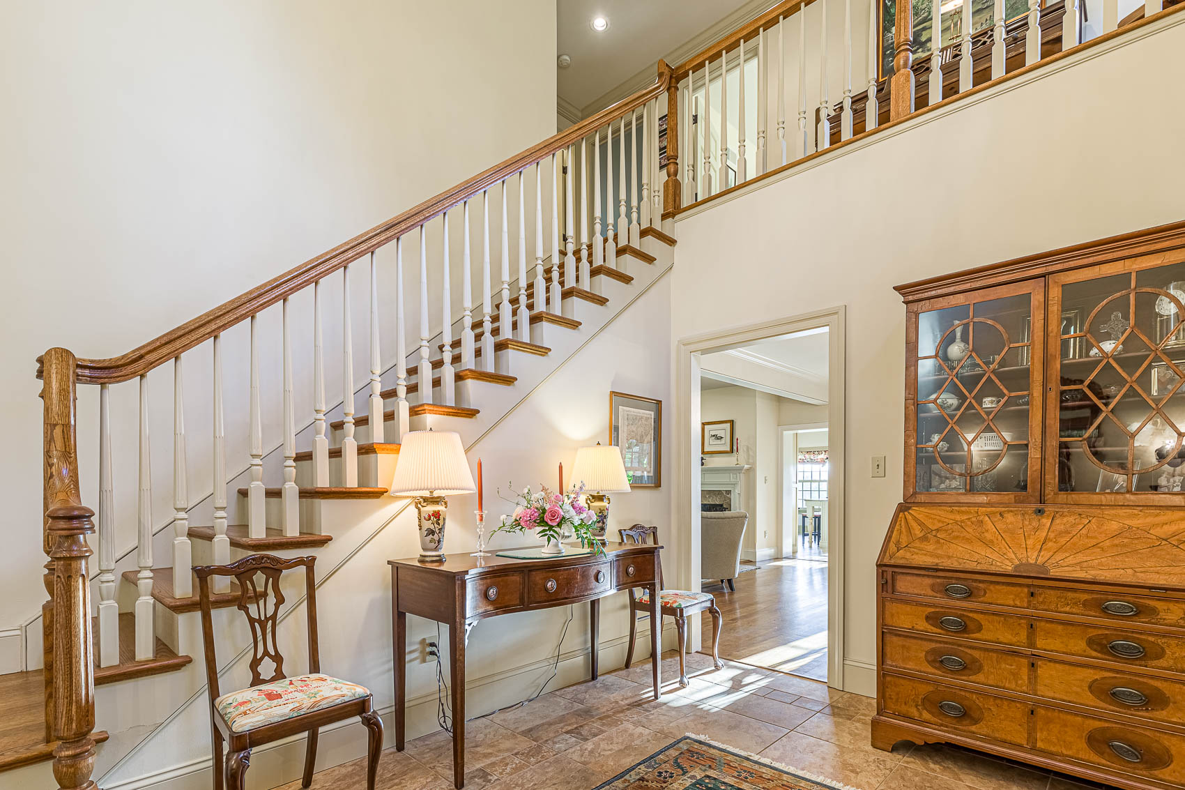 Front entryway with staircase leading up in an olde bulltown home