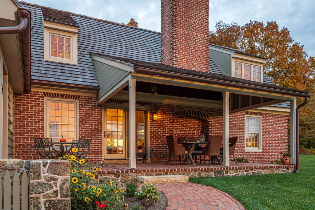 Brick patio with furniture and a fireplace in olde bulltown